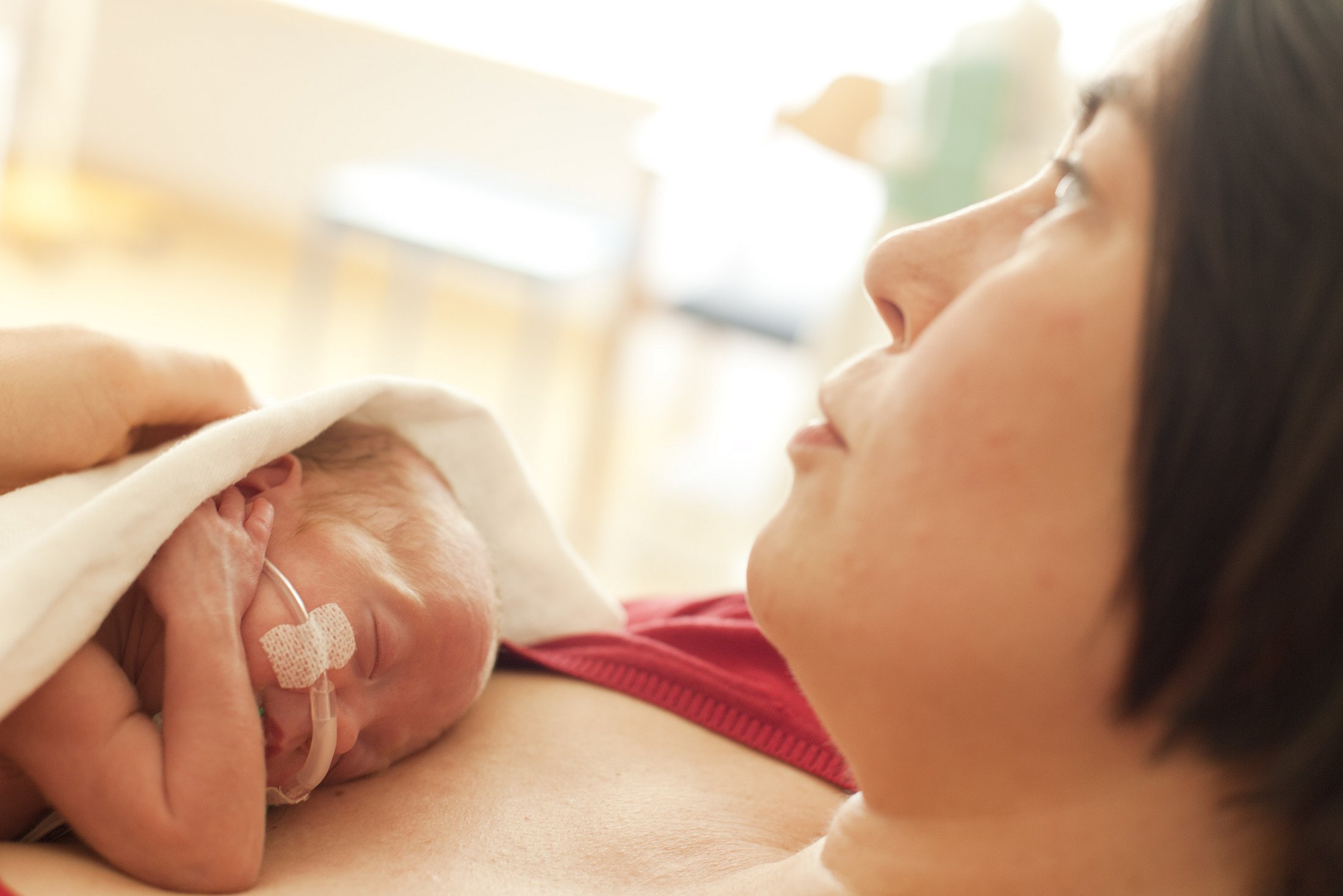 Mother holding preterm baby skin-to-skin, promoting bonding and warmth.