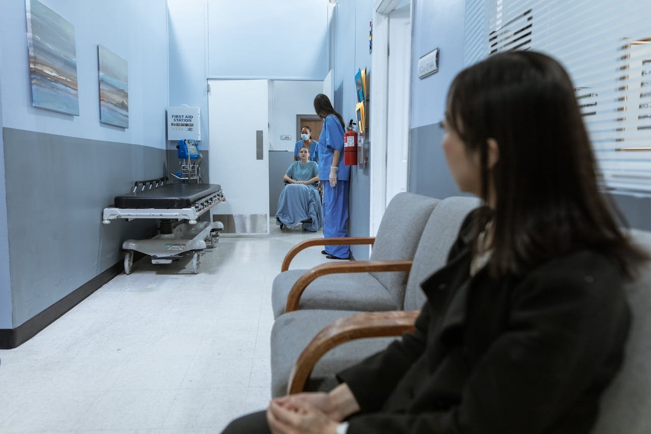 Woman sitting in a hospital waiting room.