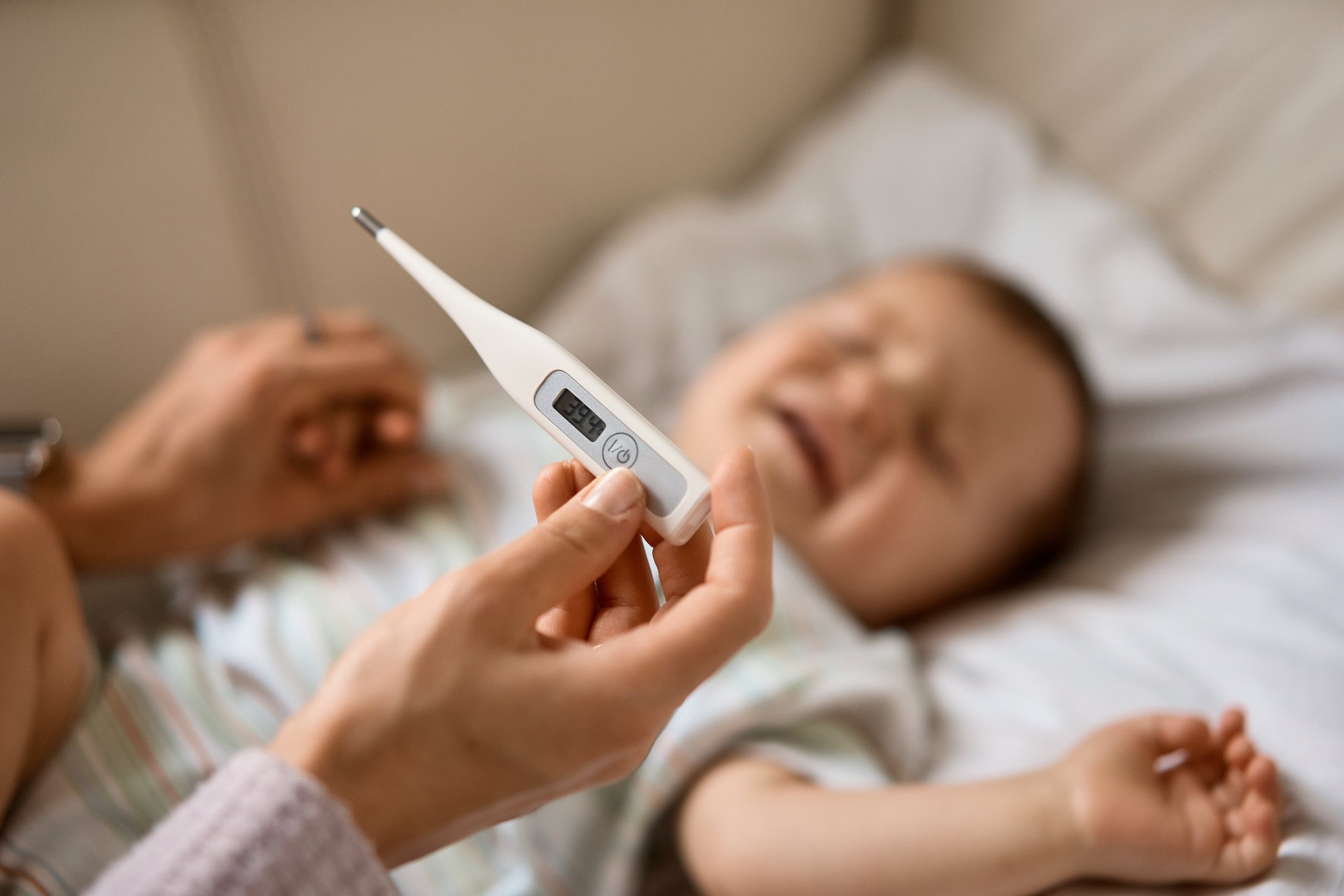 Close-up of thermometer showing baby’s temperature.