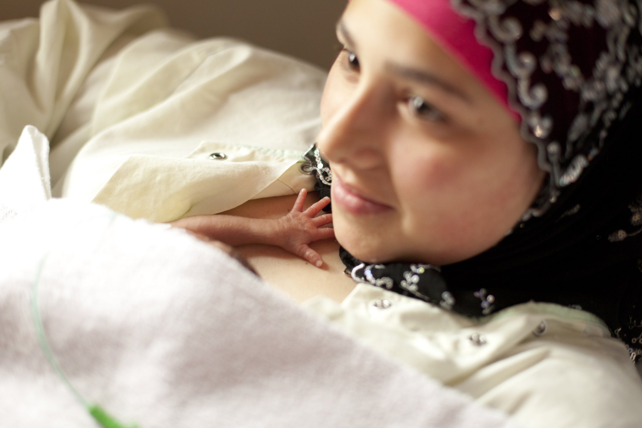 A mother providing kangaroo care to her premature baby.