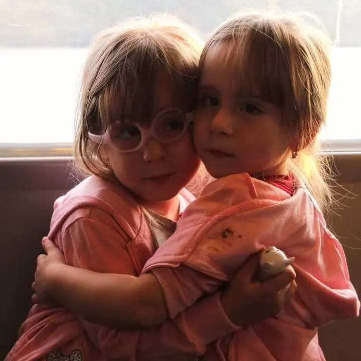 Diana and Rebeca, twin girls born preterm, cuddling in a warm embrace showing their bond and strength.